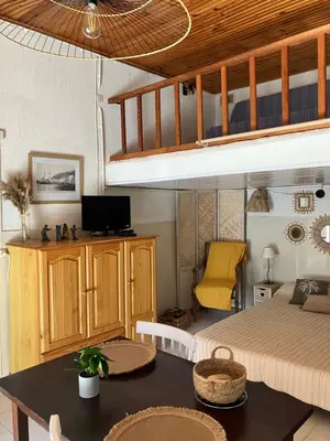 a living room with a bed and a dining table at Studio Olmeto in Olmeto