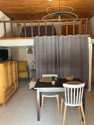 a dining room with a table and two chairs at Studio Olmeto in Olmeto