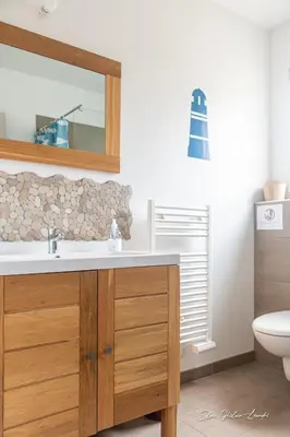a bathroom with a sink and a mirror and a toilet at Grande villa de standing avec piscine à Sagone en Corse in Sagone