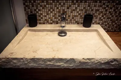a bathroom sink with a marble counter top at Grande villa de standing avec piscine à Sagone en Corse in Sagone