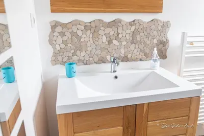 a bathroom with a white sink and a mirror at Grande villa de standing avec piscine à Sagone en Corse in Sagone