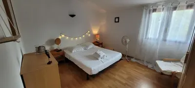 a bedroom with a bed and a dresser with a mirror at Plage Vardiola à pied Familiale 10 pers Corse Sud Porto Vecchio in Vardiola