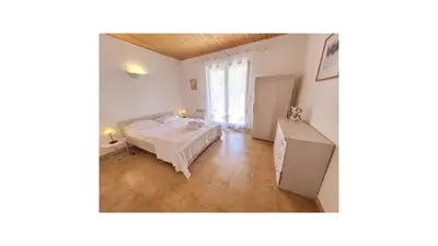 a room with a bed and a table in it at Plage Vardiola à pied Familiale 10 pers Corse Sud Porto Vecchio in Vardiola