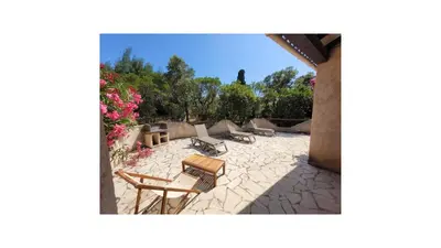 a patio with chairs and tables and flowers at Plage Vardiola à pied Familiale 10 pers Corse Sud Porto Vecchio in Vardiola