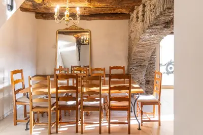 a dining room with a table and chairs and a mirror at A Macina in Porri