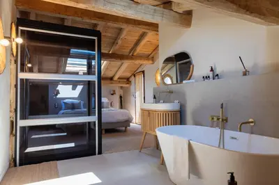 a bathroom with a tub and a bedroom at Bergerie face à Propriano in Fozzano