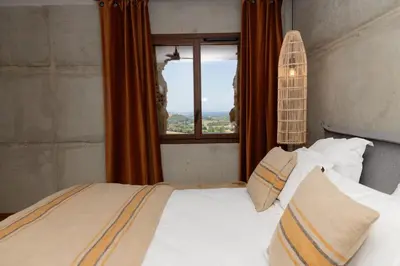 a bedroom with a bed and a window at Bergerie face à Propriano in Fozzano