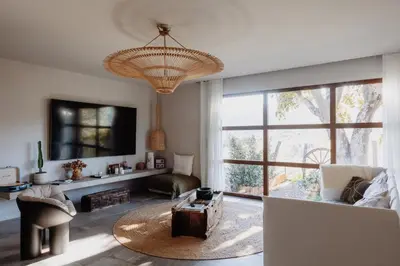 a living room with a large window and a large chandelier at Bergerie face à Propriano in Fozzano