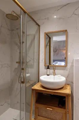a bathroom with a sink and a glass shower at Bergerie face à Propriano in Fozzano