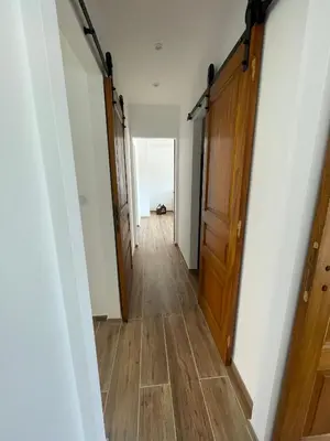 a hallway of a house with wooden floors and doors at Appartement T3 neuf centre ville in Ajaccio