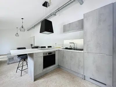 a large kitchen with a sink and a counter at Villa 2 chambres avec jacuzzi in Bonifacio