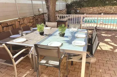 a long table with chairs and a blue tablecloth on a patio at Villa de charme Porto-Vecchio, Plage à 10 min in San-Gavino-di-Carbini