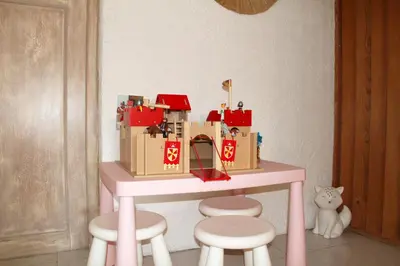 a pink table with boxes on it with stools at Villa de charme Porto-Vecchio, Plage à 10 min in San-Gavino-di-Carbini