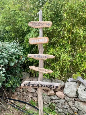 a wooden sign with street signs on it at Villa de charme Porto-Vecchio, Plage à 10 min in San-Gavino-di-Carbini
