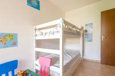 a bunk bed in a childs room with a ladder at La Marine de Bravone in Linguizzetta