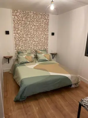 a bedroom with a large bed in a room at T2 très bien équipé vue mer et au calme in Ajaccio