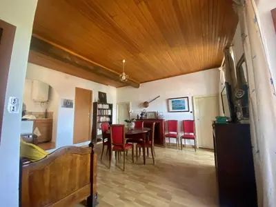 a living room and dining room with a table and chairs at Appartement 3 pièces 80 m2 Quenza in Quenza
