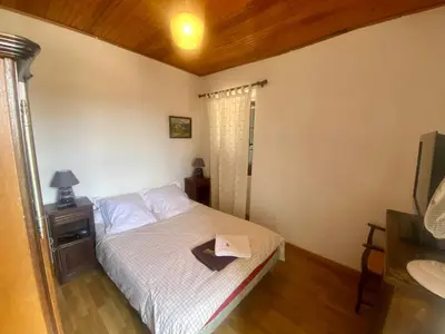 a bedroom with a bed with a napkin on it at Appartement 3 pièces 80 m2 Quenza in Quenza