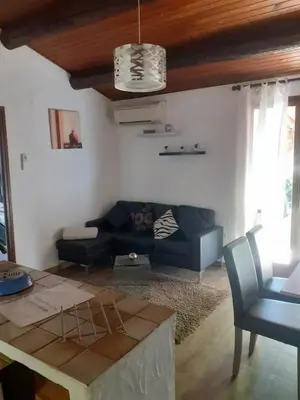 a living room with a couch and a table at Petite maison in Lecci