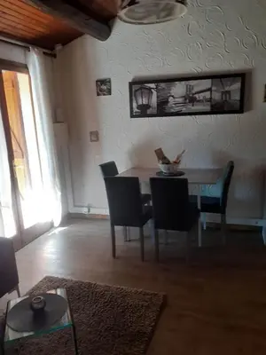 a dining room with a table and chairs in a room at Petite maison in Lecci