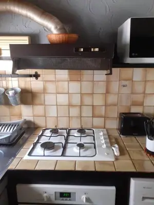 a white stove top oven in a kitchen at Petite maison in Lecci