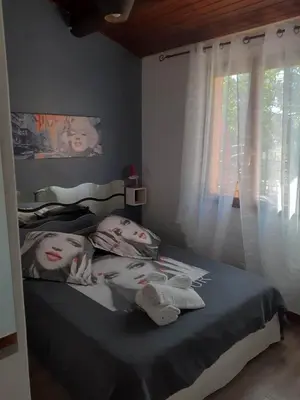 a bedroom with a bed with two dolls on it at Petite maison in Lecci