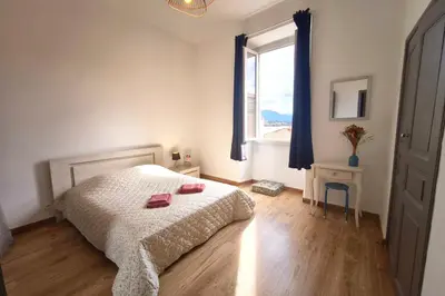 a kitchen with white cabinets and a stove top oven at Spacious cocoon close to the beach in Ajaccio