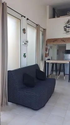 a couch in a living room with a table at Mini Villa - Vue mer in Serra-di-Ferro