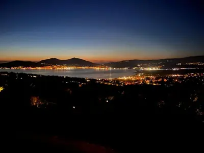 a view of a city and a river at night at LOCA VACANCES in Porticcio