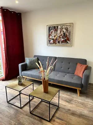 a living room with a couch and two tables at Très bel appartement à Ajaccio in Ajaccio