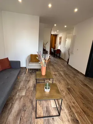 a living room with a couch and a table at Très bel appartement à Ajaccio in Ajaccio