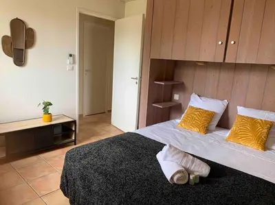 a bedroom with a large bed with yellow pillows at Plage à pied : Mini villa Saint-Cyprien in Lecci