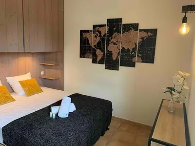a bedroom with a bed and a map on the wall at Plage à pied : Mini villa Saint-Cyprien in Lecci