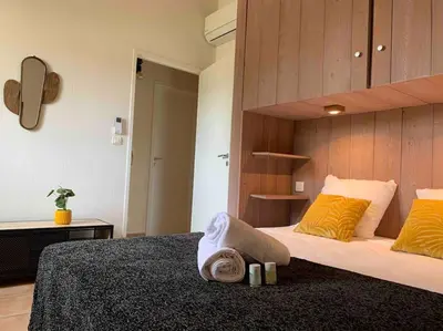 a bedroom with a large bed with yellow pillows at Plage à pied : Mini villa Saint-Cyprien in Lecci