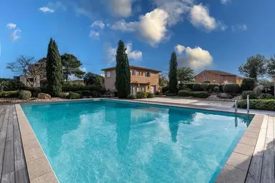 a large swimming pool in a yard with a house at Plage à pied : Mini villa Saint-Cyprien in Lecci