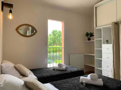 a bedroom with a bed and a mirror and a window at Plage à pied : Mini villa Saint-Cyprien in Lecci