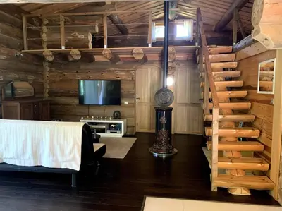 a room with a bed and a tv and a staircase at Hébergement d'exception à Zonza in Zonza