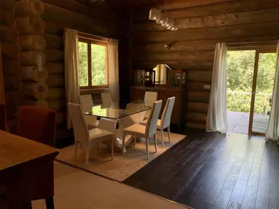 a dining room with a table and chairs in a cabin at Hébergement d'exception à Zonza in Zonza