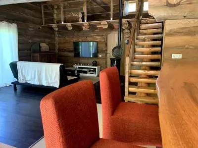 a living room with two chairs and a table at Hébergement d'exception à Zonza in Zonza