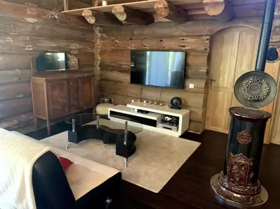 a living room with a tv and a couch and a bed at Hébergement d'exception à Zonza in Zonza