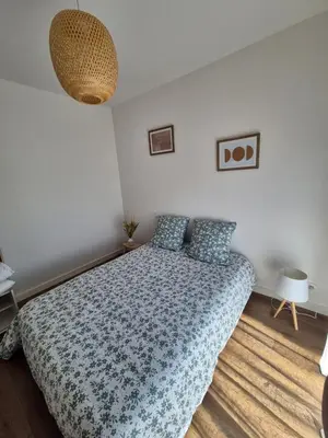 a bedroom with a bed with a blue comforter at Vista mare in Ajaccio