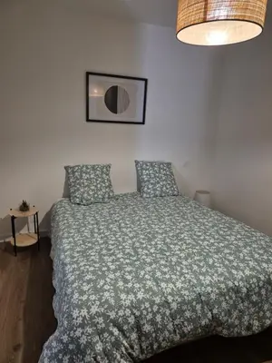 a bedroom with a bed with a green comforter at Vista mare in Ajaccio