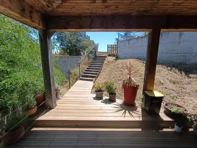 a wooden walkway with potted plants on it at T3 en rez de villa sur les hauteurs d'Ajaccio in Ajaccio