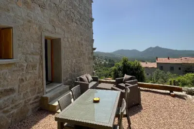 a table and chairs on a patio with a view at Casetta Tozza Di Conca in Conca