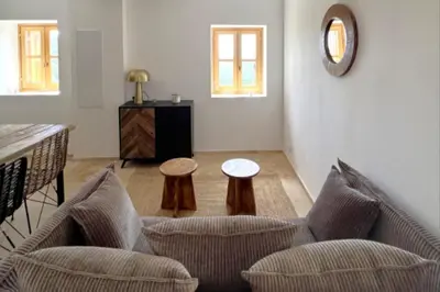 a living room with two chairs and a table at Casetta Tozza Di Conca in Conca