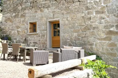 a patio with chairs and a table and a building at Casetta Tozza Di Conca in Conca