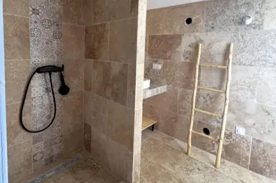 a bathroom with a shower with a ladder in it at Casetta Tozza Di Conca in Conca