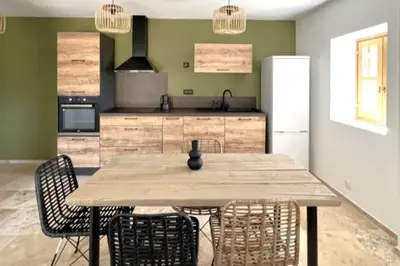 a kitchen with a wooden table and chairs at Casetta Tozza Di Conca in Conca