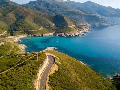 an aerial view of a road next to the ocean at Appartement central avec très jolie vue in Ajaccio