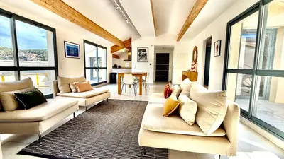 a living room with two couches and a table at Sur le port, 150m2 - Parking gratuit, Climatisation, Terrasses - Standing in Bonifacio
